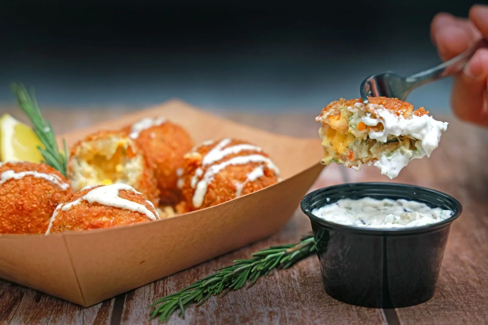 Bouchées panées dorées, l'une ouverte sur son cœur fondant, avec une sauce crémeuse
